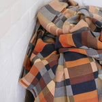 Plaid blanket with autumn colors on a white background