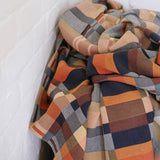 Plaid blanket with autumn colors on a white background