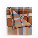 Plaid blanket with autumnal colors on a white background