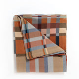 Plaid blanket with autumnal colors on a white background