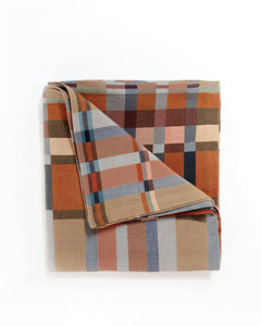 Plaid blanket with autumnal colors on a white background