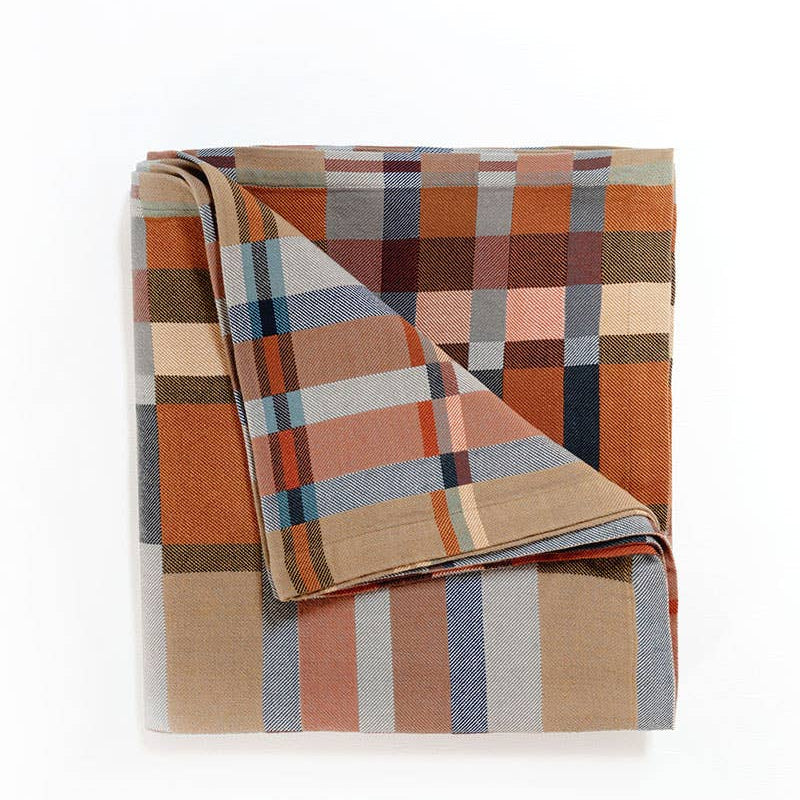 Plaid blanket with autumnal colors on a white background