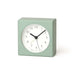 Light green square clock with a white face on a white background