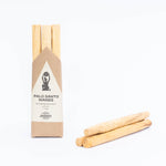 Palo Santo wands with packaging on a white background