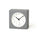 Gray square clock with a white face on a white background