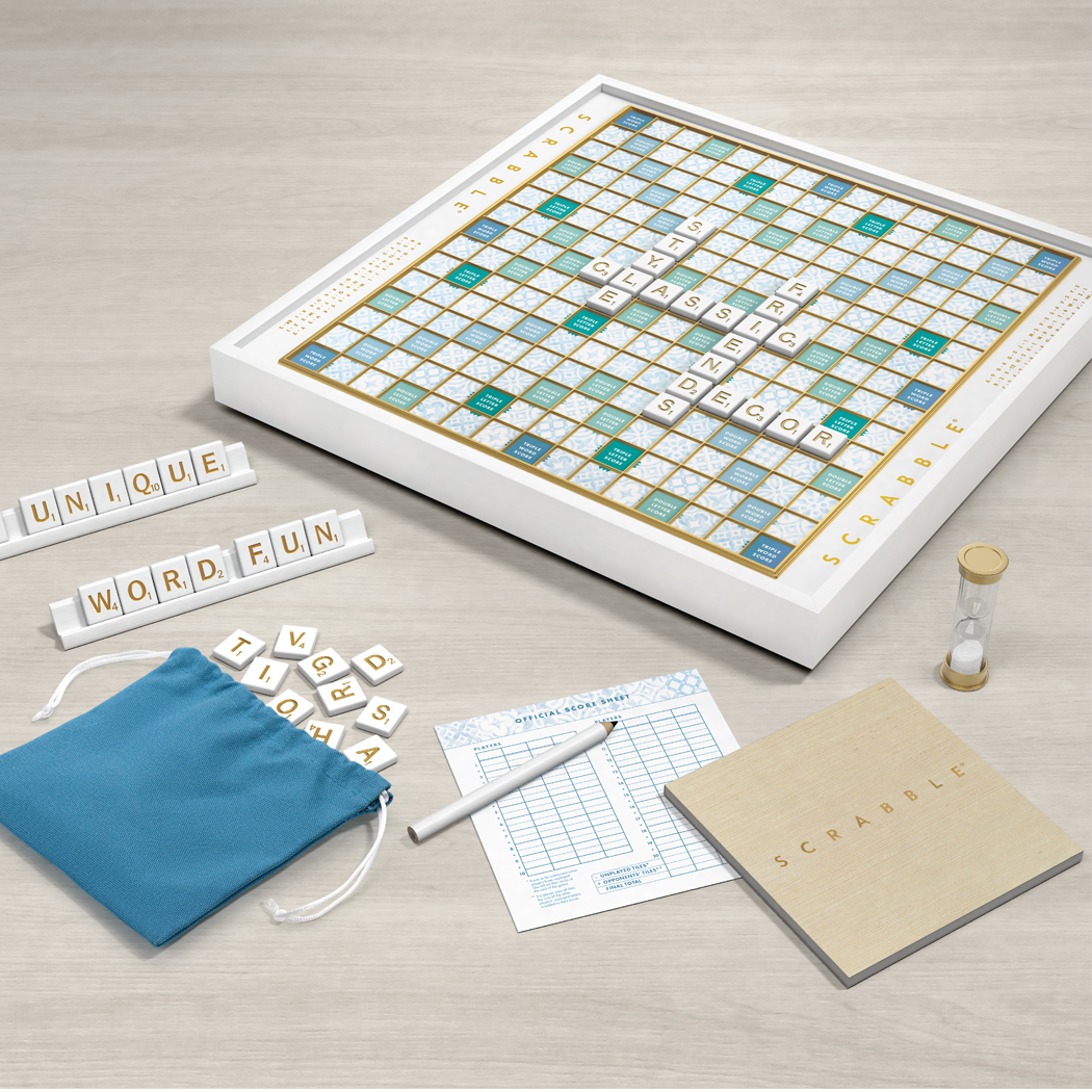 Scrabble board game set with tiles, bag, and score sheet on a light surface