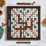 Scrabble board game on a table with tiles and food.