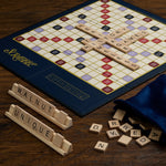 Scrabble board game with tiles and pieces on a wooden surface