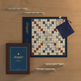 Scrabble board game set on a wooden surface with wood tiles and pouch