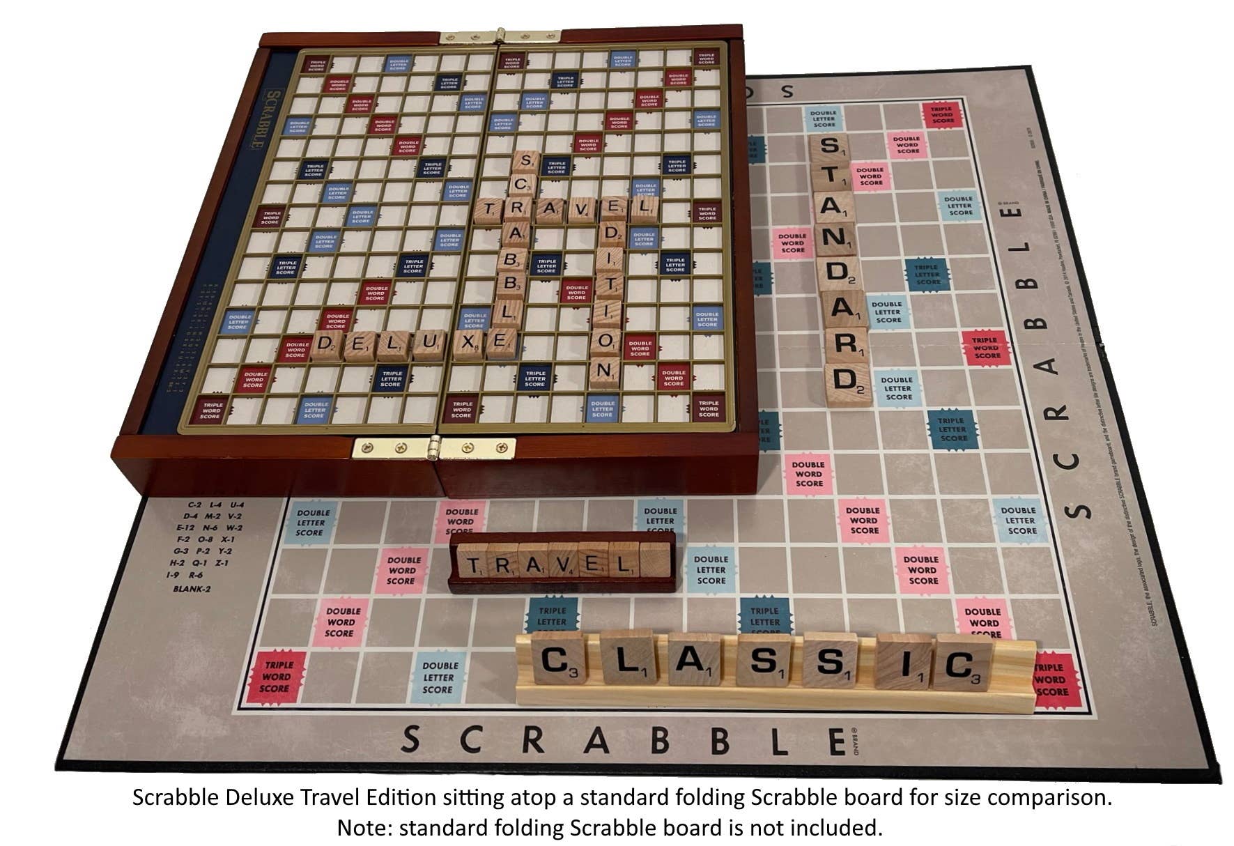 Scrabble Deluxe Travel Edition on a standard folding Scrabble board and two sets of tiles for size comparison.