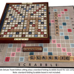 Scrabble Deluxe Travel Edition on a standard folding Scrabble board and two sets of tiles for size comparison.