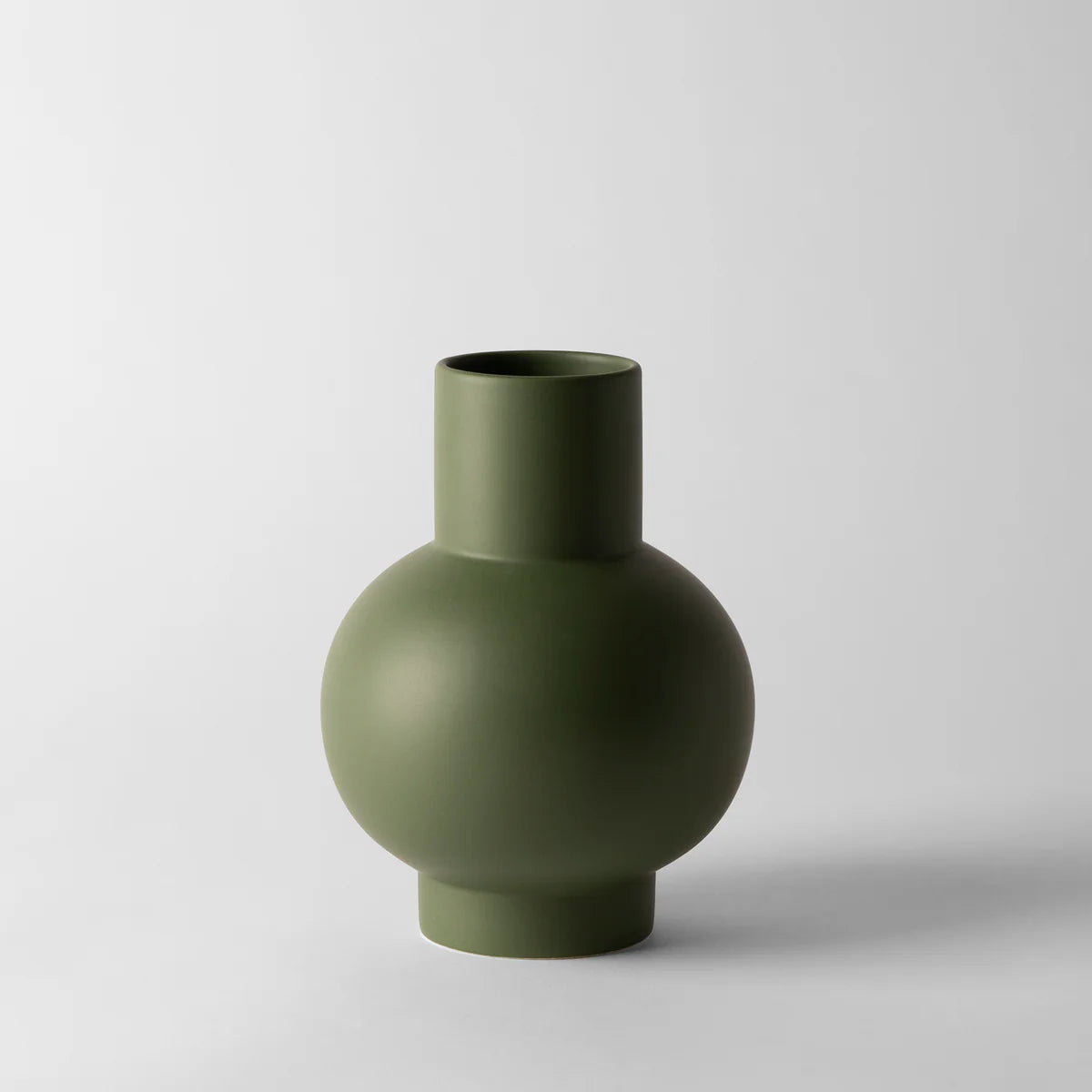 Green vase on a light gray background