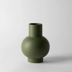Green vase on a light gray background