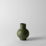Green vase on a light gray background