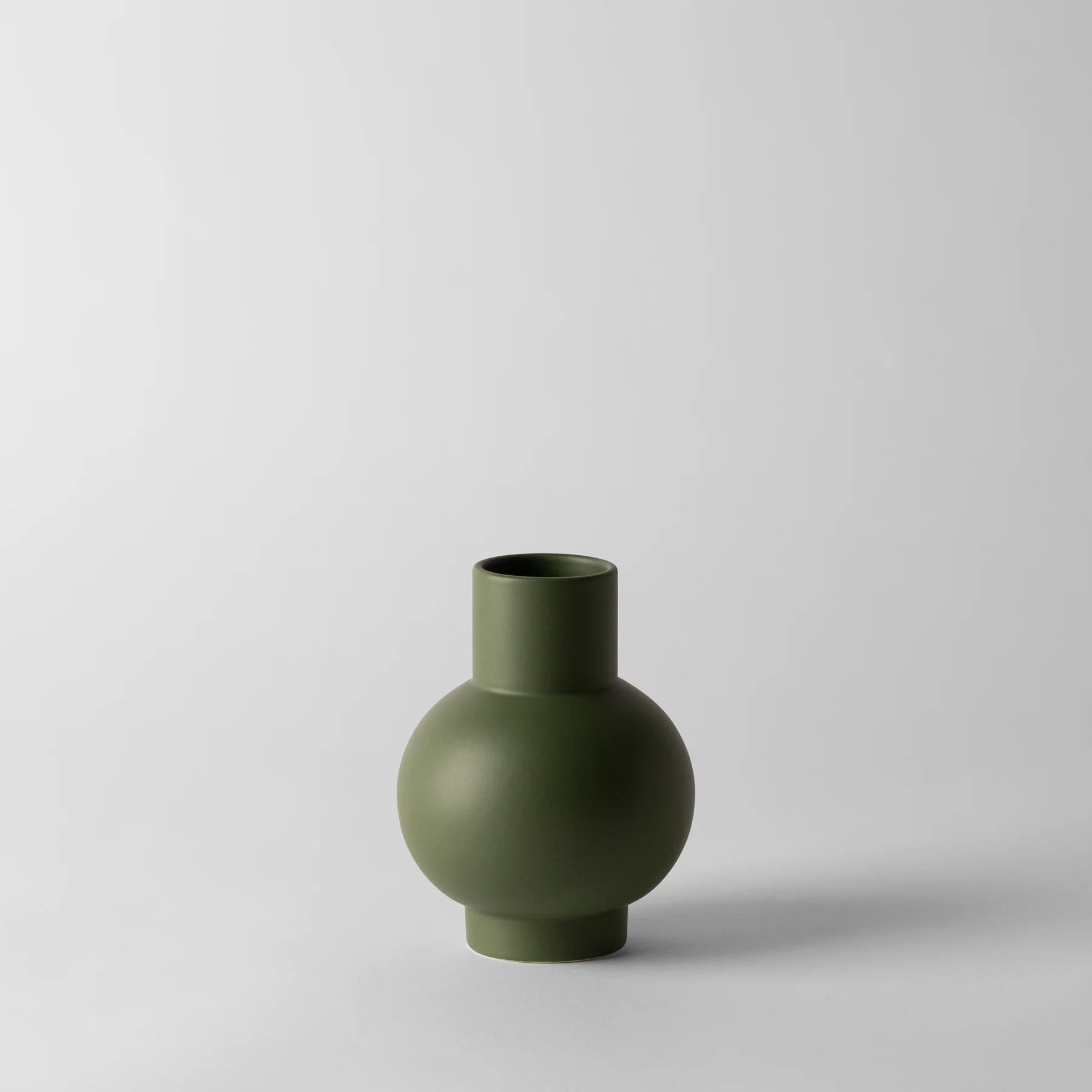 Green vase on a light gray background