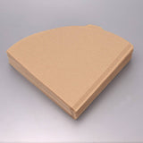 Stack of v shaped brown paper coffee filters on a gray background