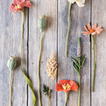assorted felt flowers on wooden surface