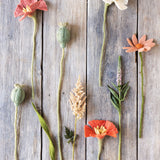 assorted felt flowers on wooden surface