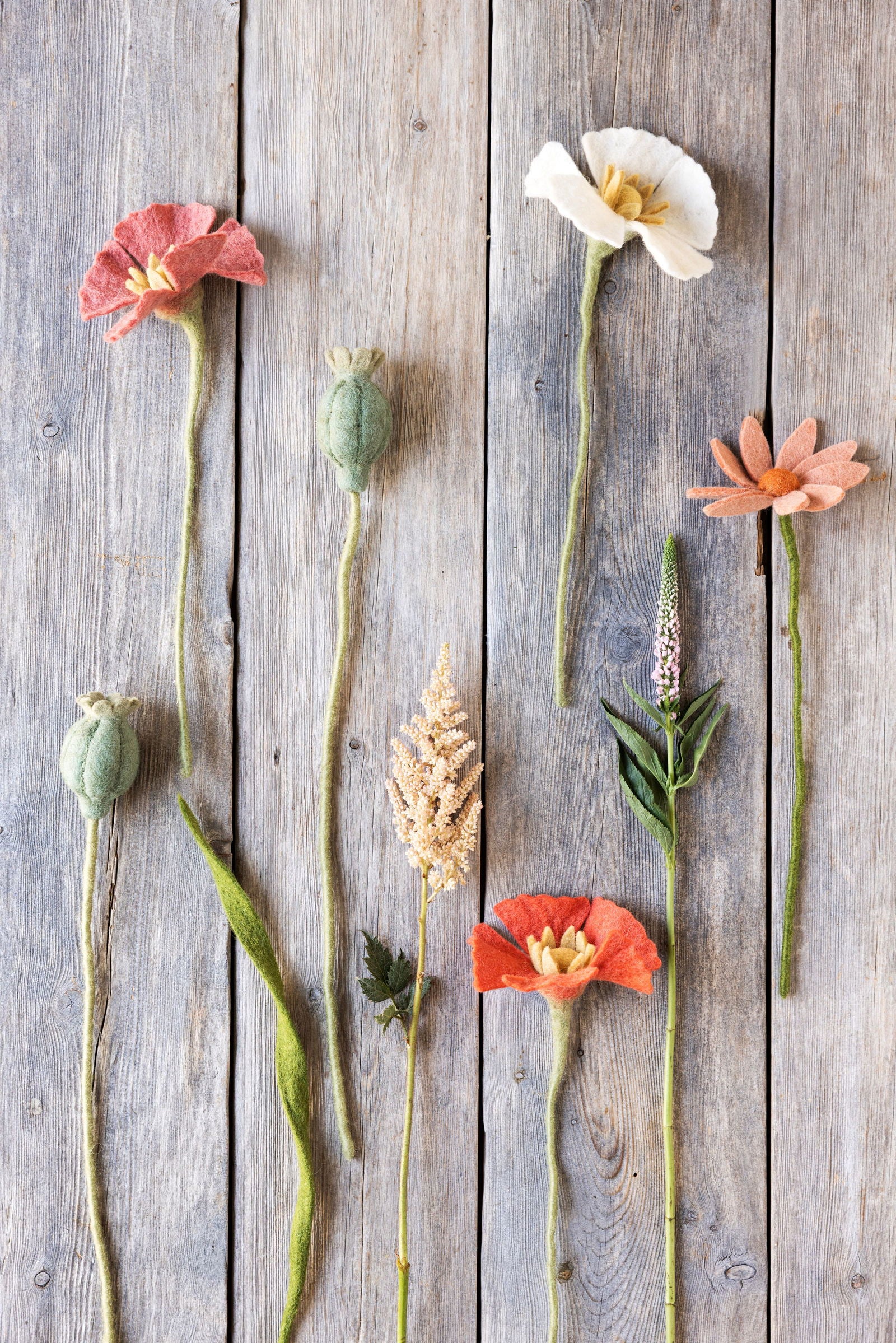 assorted felt flowers on wooden surface