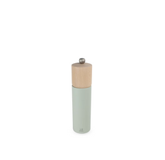 salt mill with wooden top and light green body on a white background