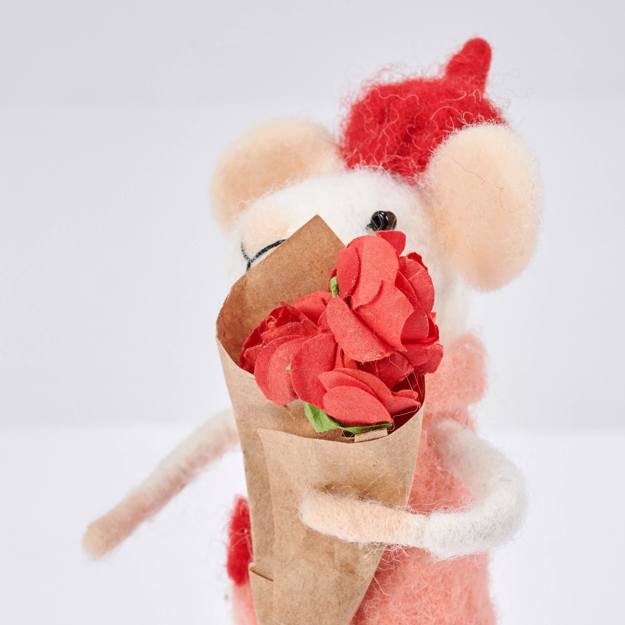 closeup of mouse with a bouquet of red flowers on a light gray background