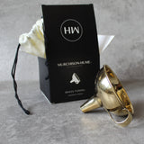 Gold brass funnel with Murchison-Hume box on a gray surface