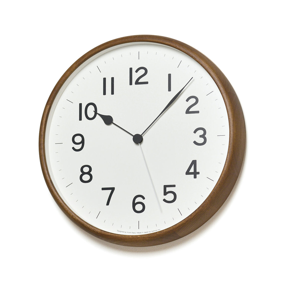Large round wall clock with dark wooden frame on a white background
