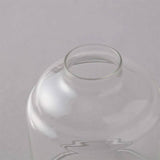Clear glass vase on a light gray background