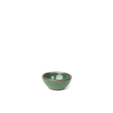 A tiny rounded ceramic bowl in a glossy emerald green color featuring iron speckles and an unglazed rim