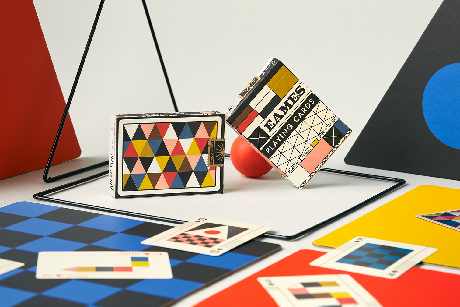 Colorful playing cards with geometric designs on a checkered surface