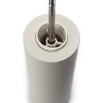 Inside view of white salt grinder with metal core on a white background