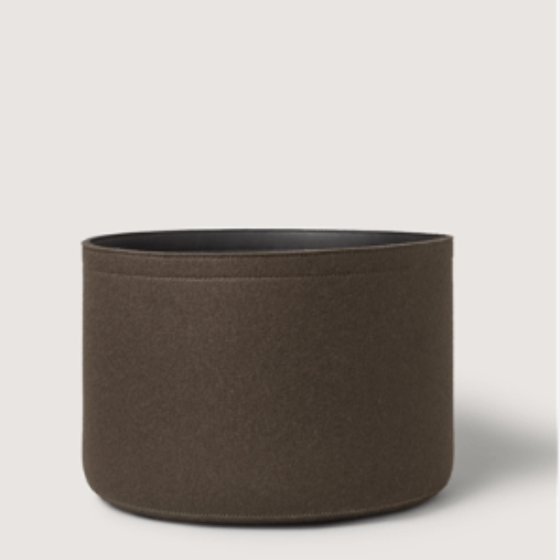 Brown cylindrical fabric planter on a light gray background
