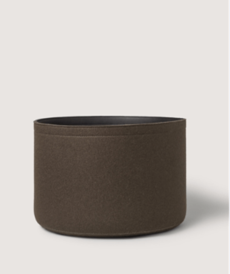 Brown cylindrical fabric planter on a light gray background