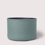 Blue cylindrical fabric basket on a light gray background