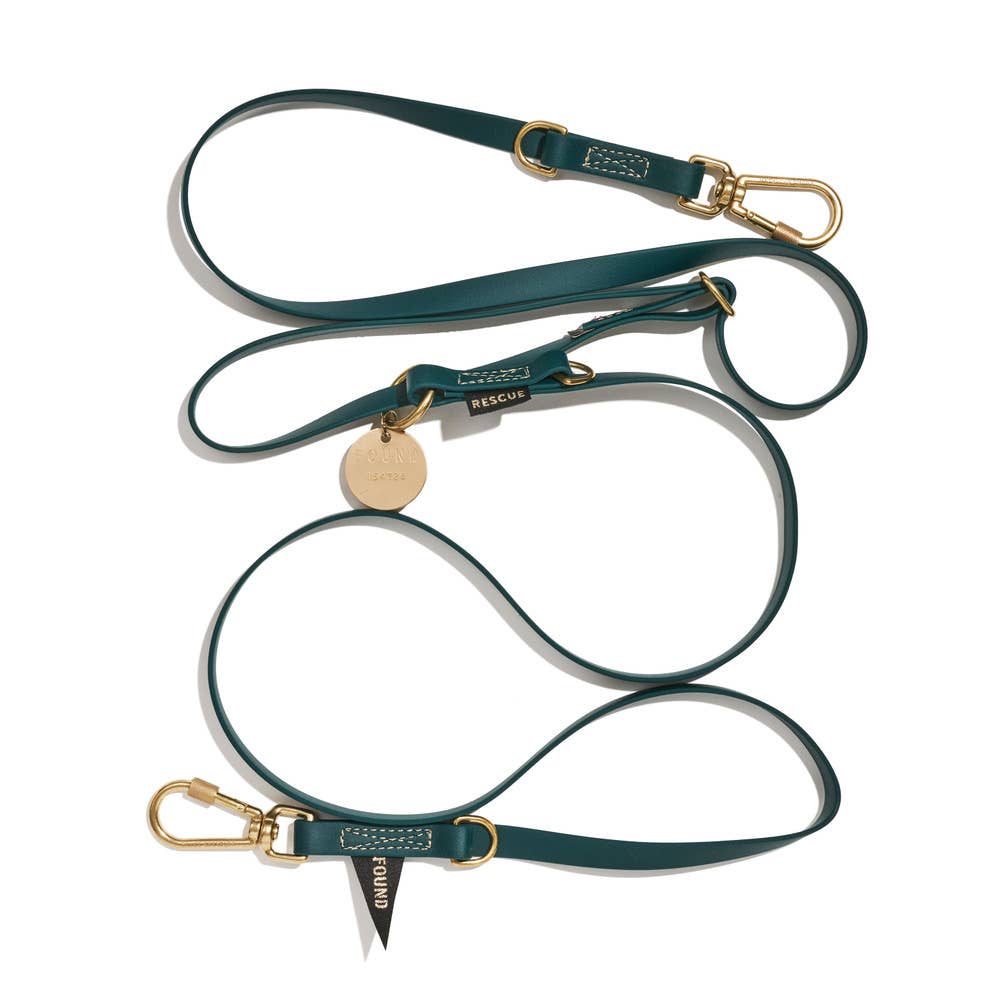 An adjustable, hunter green colored dog leash with brass lockable carabiners and rubber coated webbing.
