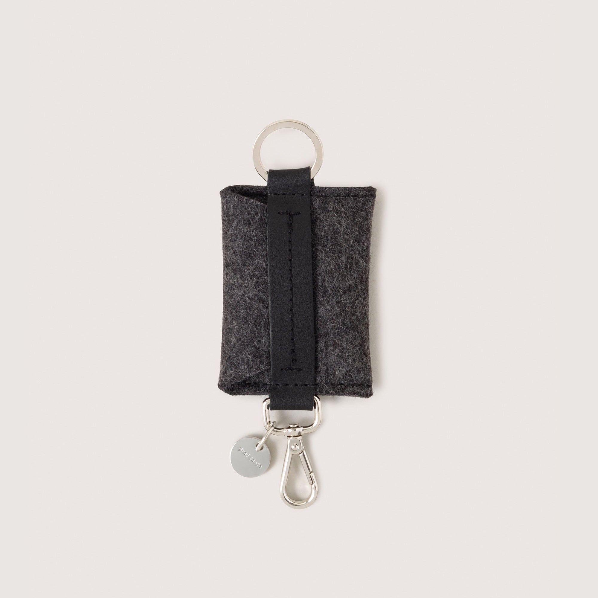 Charcoal Merino Wool Card Key Fob with silver colored Lobster Clasp, Flat Wide Keyring, and Logo Tog Tag, white background.