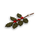 Decorative holly branch with red berries on a white background