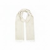 A light beige woven scarf with fringed edges, draped in a looped style against a plain white background.