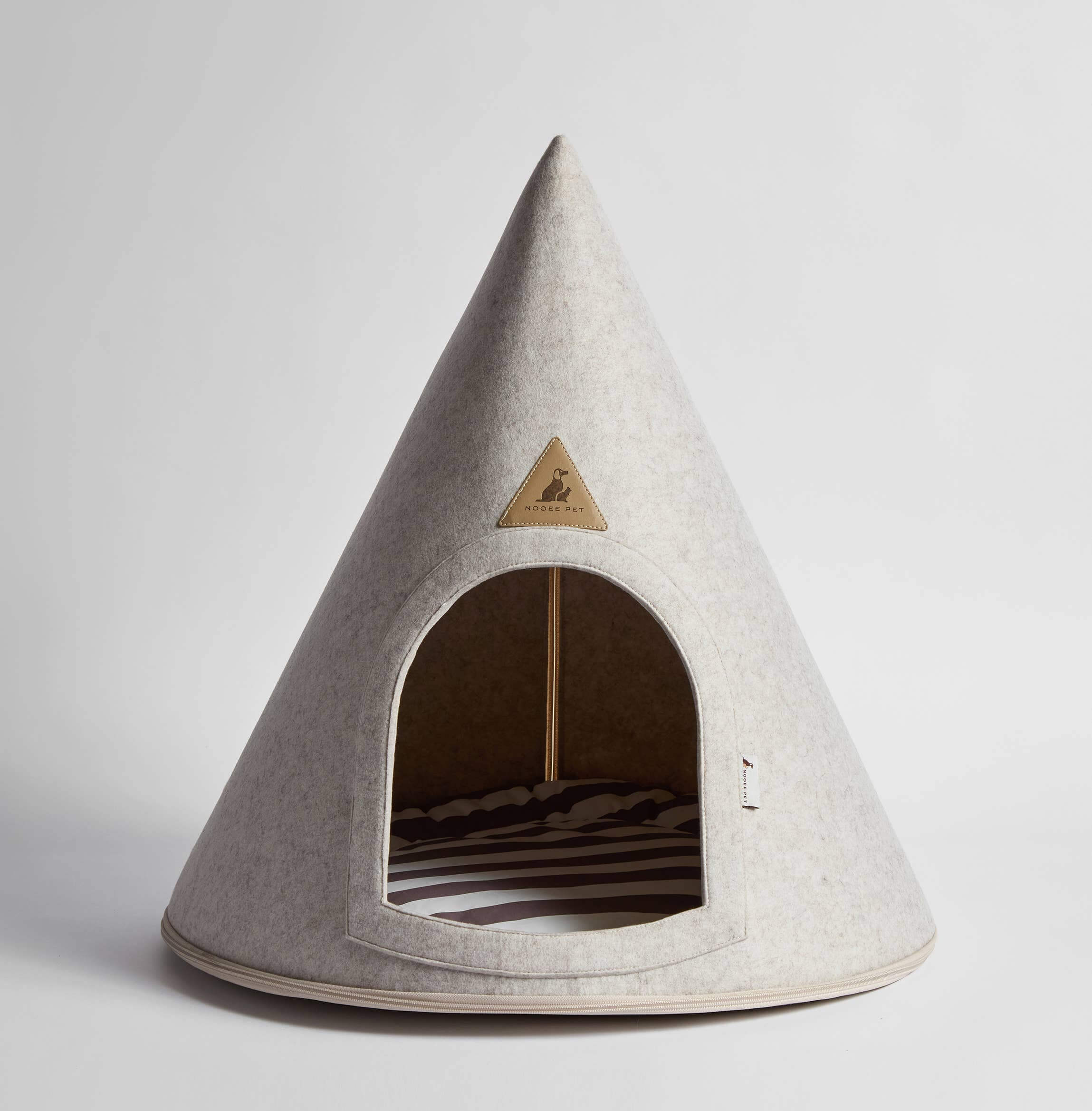 Teepee-shaped pet bed with a triangular logo on a light gray background