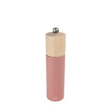 Pink pepper grinder with wooden top on a black background