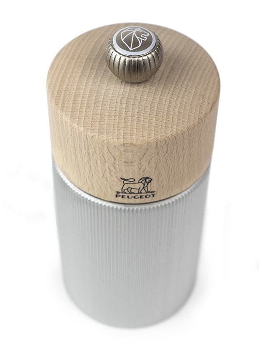 Top view of Peugeot salt mill with wooden top and striated metal body.