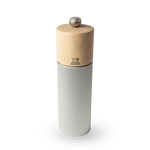Pepper grinder with wooden top and ribbed metal body on a white background