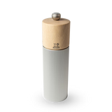 Pepper grinder with wooden top and ribbed metal body on a white background