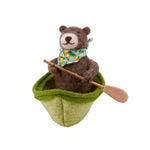 felt bear in a green kayak with a paddle 