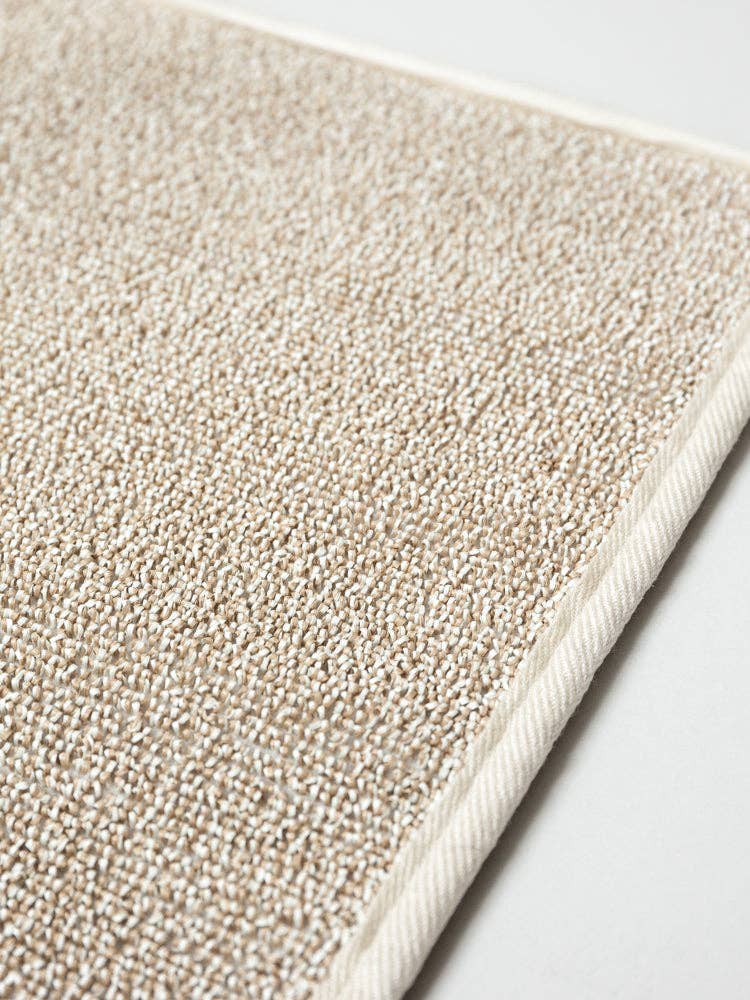 closeup of portion of beige sasawashi bath mat surface with small loops