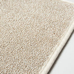 closeup of portion of beige sasawashi bath mat surface with small loops