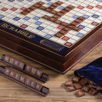 Scrabble board game with tiles and bag on a wooden surface