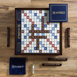 Scrabble board game set on a wooden surface with tiles and bags.