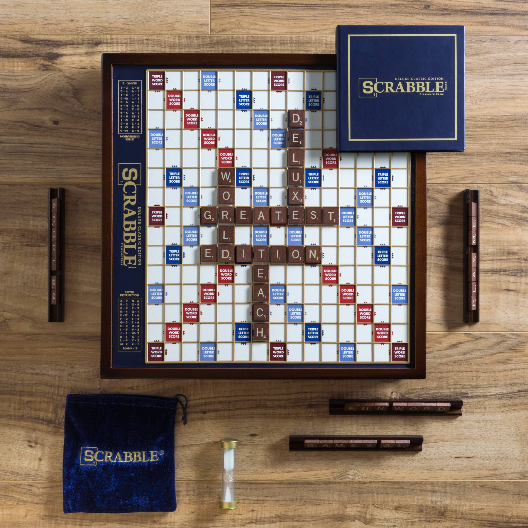 Scrabble board game set on a wooden surface with tiles and bags.