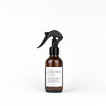 Brown spray bottle with black nozzle on a white background